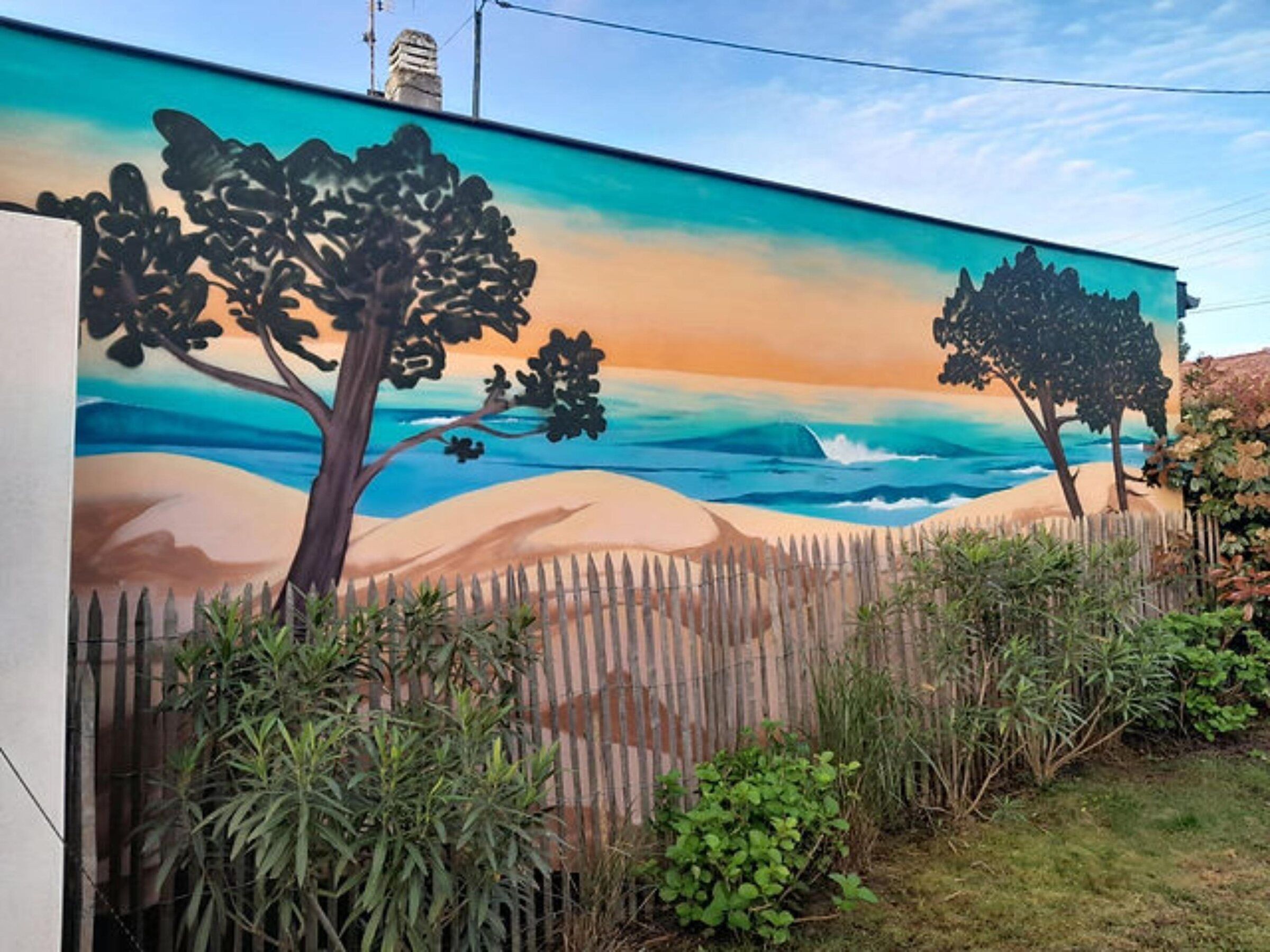 Mur de jardin peint d'un paysage de dunes, de pins et d'océan au coucher du soleil
